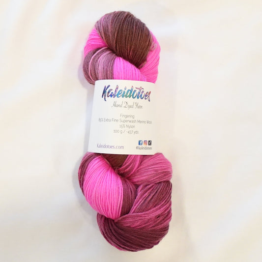 Hand-dyed yarn in deep brown, plum, and electric pink tones — rich and bold with a high-contrast, velvety finish.