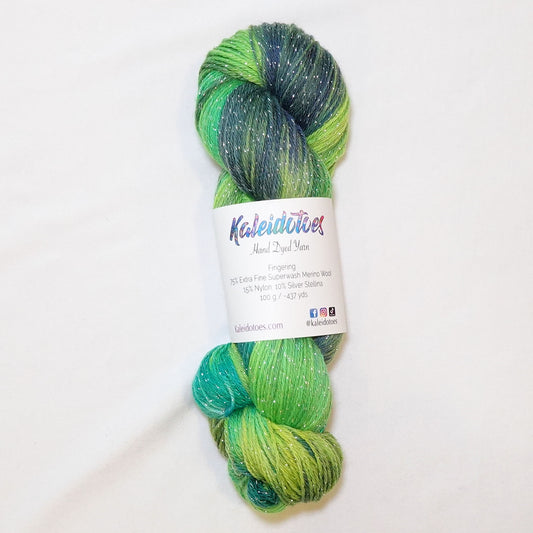 Hand-dyed fingering weight yarn in electric lime, chartreuse, emerald, and turquoise with navy shadows and silver metallic thread throughout.