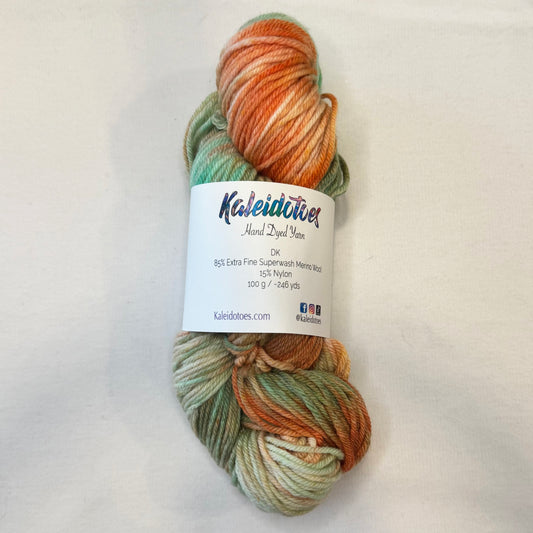 Hand-dyed yarn in soft mint, gold, and copper tones — warm and vintage with subtle modern elegance.