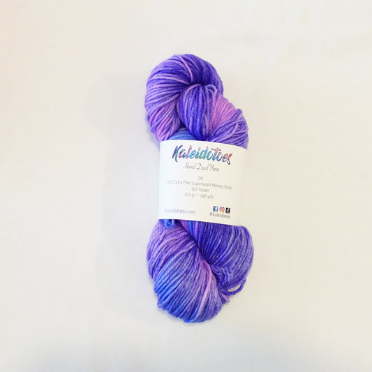 Hand-dyed yarn skein with layered pink and purple tones blended smoothly with soft tonal transitions