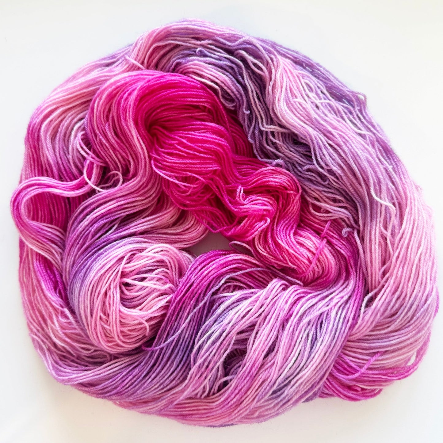 Indie dyed yarn skein, Bloomageddon, deep fuchsia and violet with soft lilac