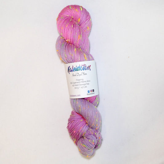 Hand-dyed yarn in soft lavender, lilac, and light pink tones with bright neon flecks — dreamy, airy, and softly blended.