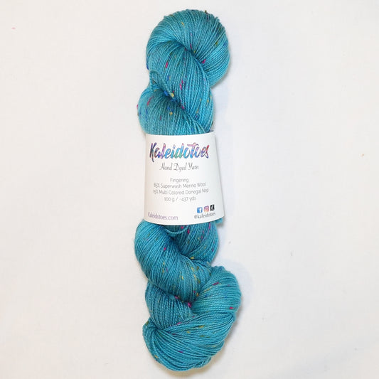 Hand-dyed yarn in layered teal and aqua tones with colorful flecks — vibrant, fresh, and reminiscent of dragonfly wings in motion.