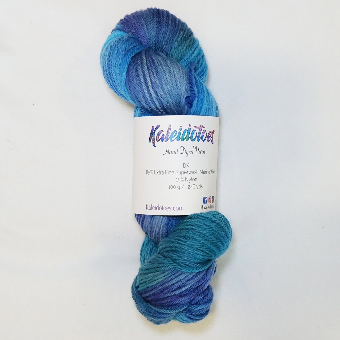 Hand-dyed DK weight yarn in bright turquoise, teal-green, blue-purple, and blue-grey - variegated and deeply saturated throughout.