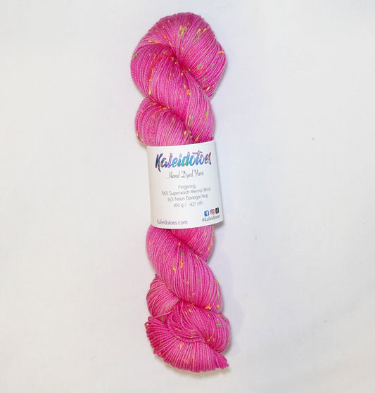 Hand-dyed yarn in vibrant pink tones with bright neon flecks — bold, playful, and full of lively movement.
