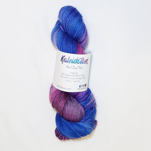 Hand-dyed fingering weight yarn in royal purple, sapphire blue, orchid pink, and magenta with saturated jewel-tone color transitions.