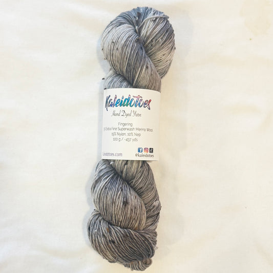 Hand-dyed yarn in soft grey and muted taupe tones — subtle, warm neutrals with gentle variation and a calm, understated feel.