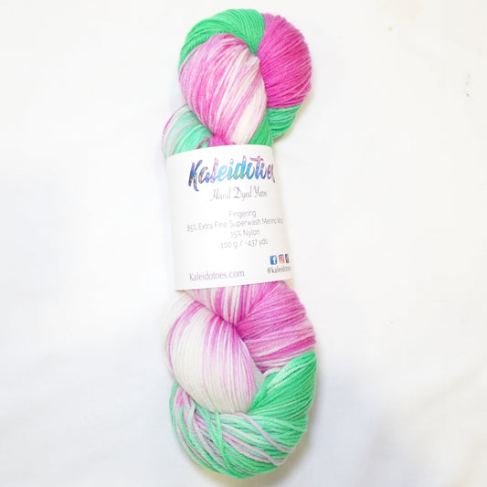 Hand-dyed yarn in bold green, hot fuchsia pink, and soft white — bright, playful, and summer-ready.