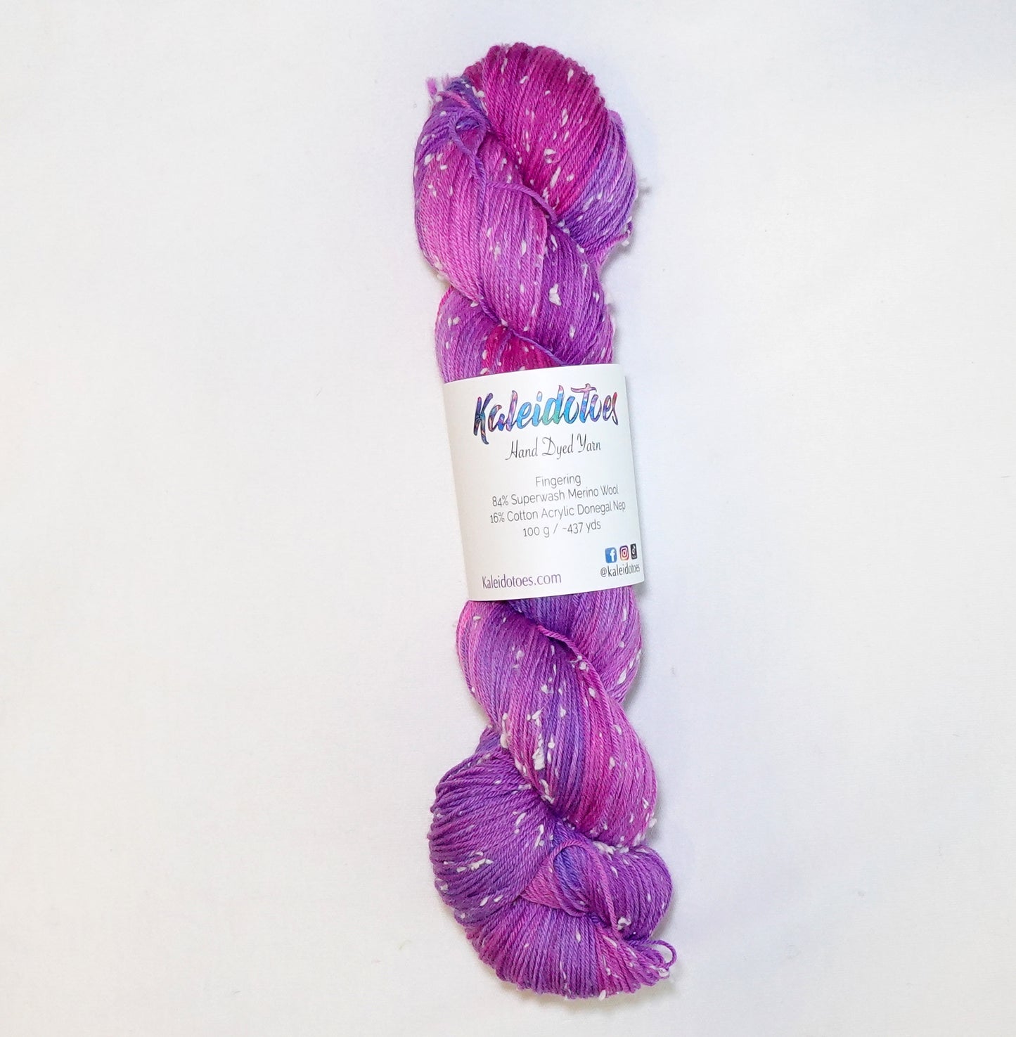 Hand-dyed yarn in vibrant violet, lavender, and bright pink tones with soft white flecks — playful, bold, and full of movement.