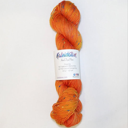 Hand-dyed yarn in vibrant orange tones with colorful flecks — bold, warm, and inspired by blooming tiger lilies.