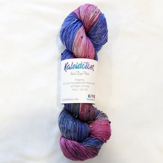 Hand-dyed tweed yarn in bold deep blue and rich raspberry with grey blending tones and subtle flecks throughout — rich, saturated, and dramatically layered.
