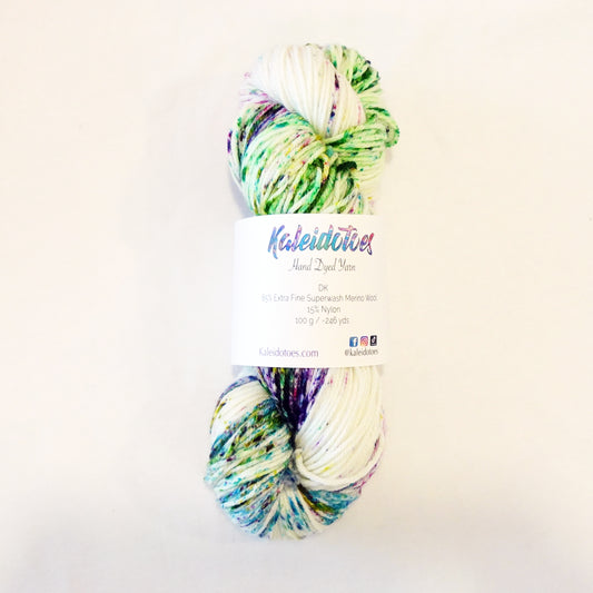 Hand-dyed yarn skein with bright floral speckles in purple, pink, green, and blue on a light base