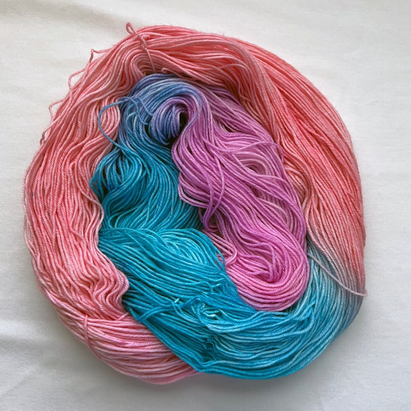 Indie dyed yarn skein, Sugarplum Princess, pastel pink and lilac with turquoise accents