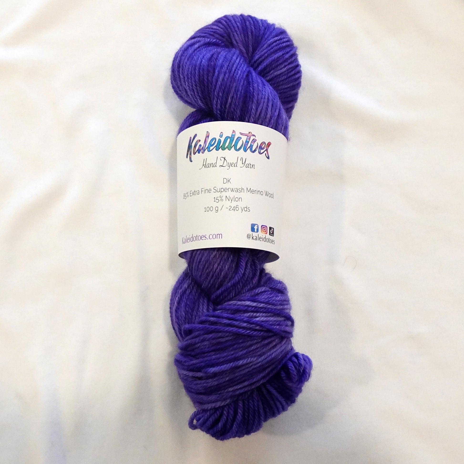Hand-dyed DK weight yarn in deep royal purple with subtle tonal variation — rich, bold, and regal.