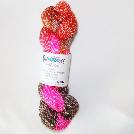 Hand-dyed white zebra base fingering weight yarn in hot pink, bright orange, and coffee brown with white plied throughout.