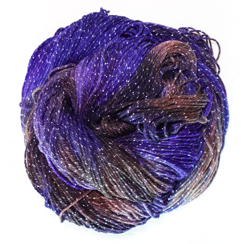 Decadent Behavior hand-dyed fingering weight yarn in saturated violet and deep chocolate brown with rich plum tones and a fine silver metallic thread.
