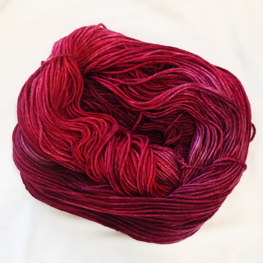 Hand-dyed yarn in deep garnet red tonal shades with rich wine undertones and dramatic jewel-like depth, inspired by Egyptian royalty and ancient dynasties.