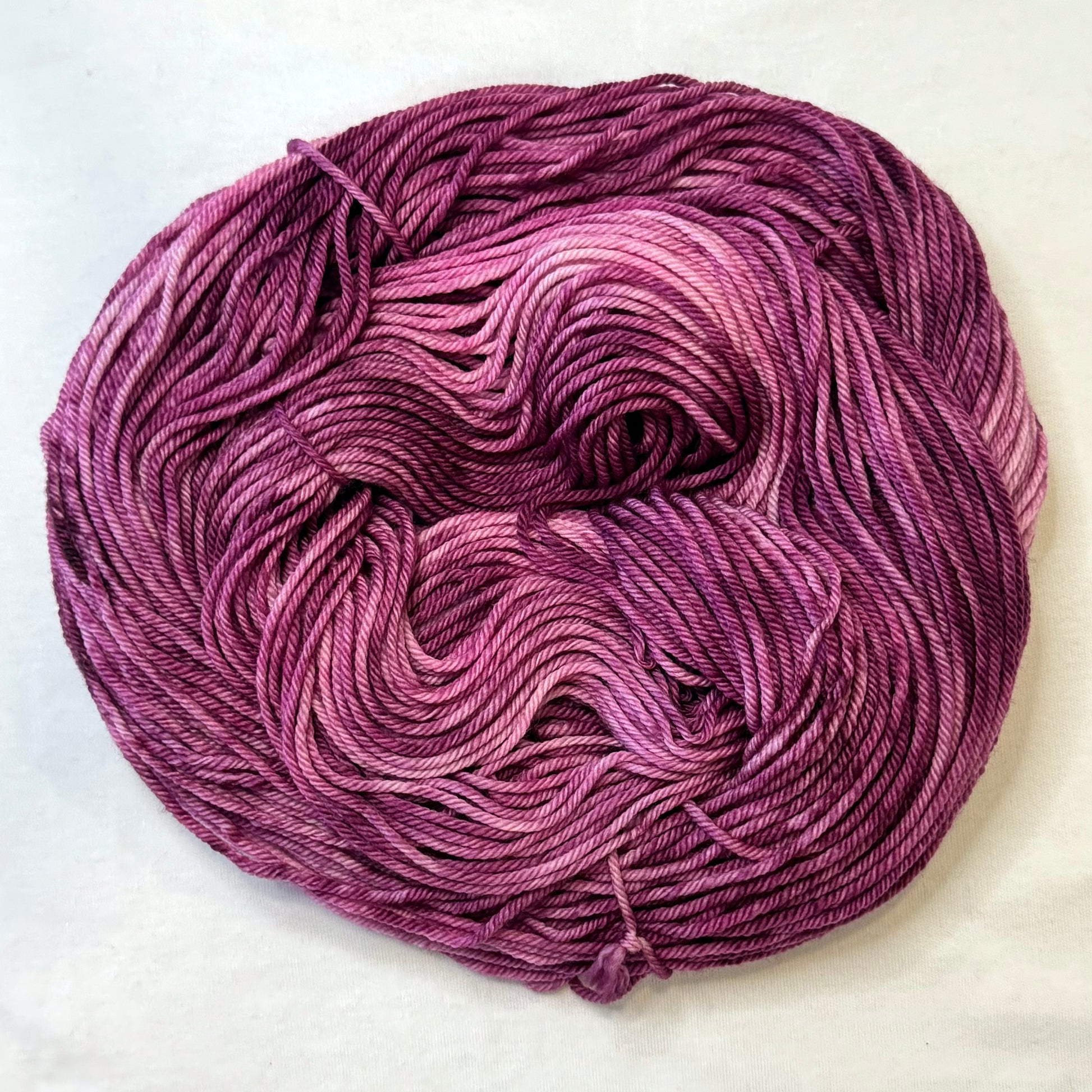 Hand-dyed yarn in deep berry, plum, and rose tones --rich, glamorous, and tonal.