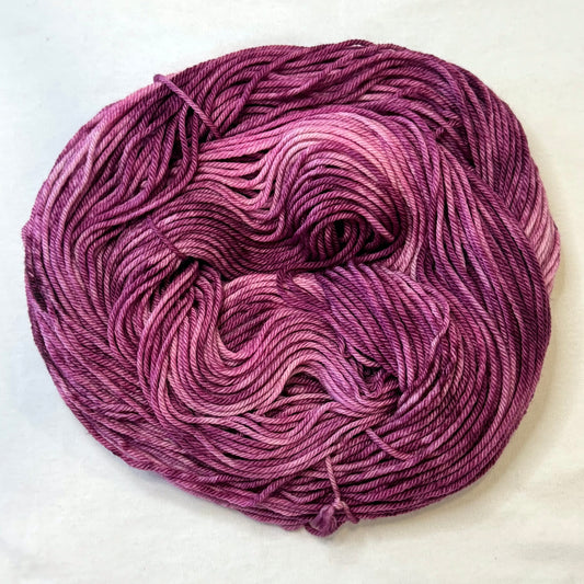 Hand-dyed yarn in deep berry, plum, and rose tones --rich, glamorous, and tonal.