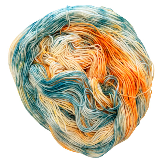 Hand-dyed fingering weight yarn in soft aqua, teal, golden orange, and cream with fluid variegated movement inspired by koi fish.