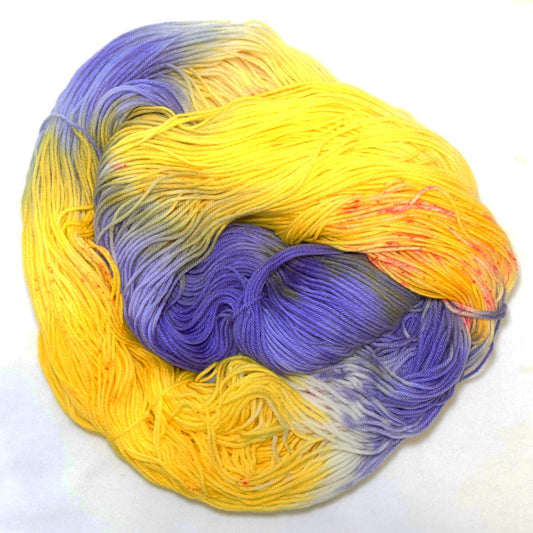 Hand-dyed yarn in bright yellow, lavender, and violet tones — fresh and vibrant with a soft, citrus-inspired feel.