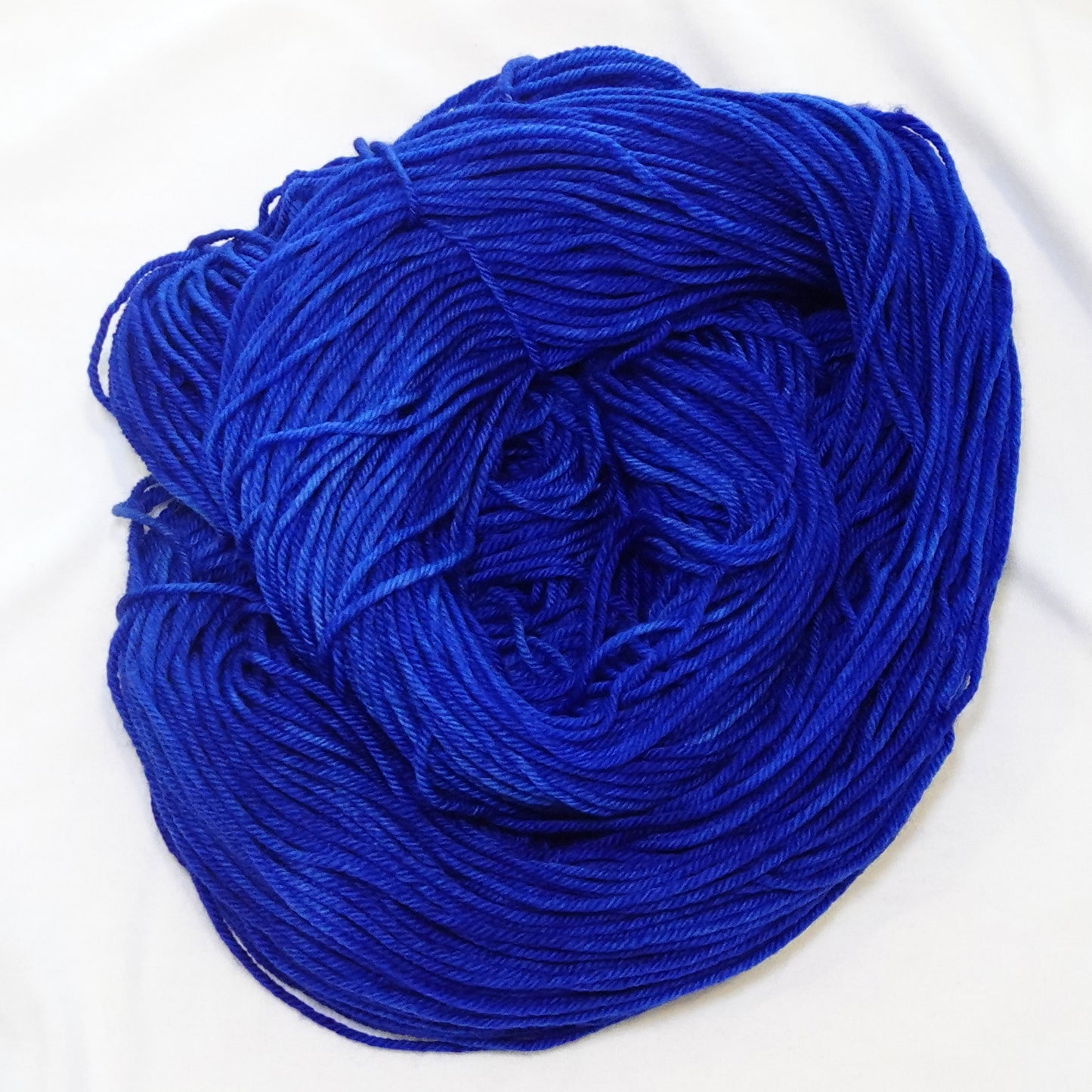 Hand-dyed DK weight yarn in deep royal lapis blue with subtle tonal variation — bold, rich, and regal.