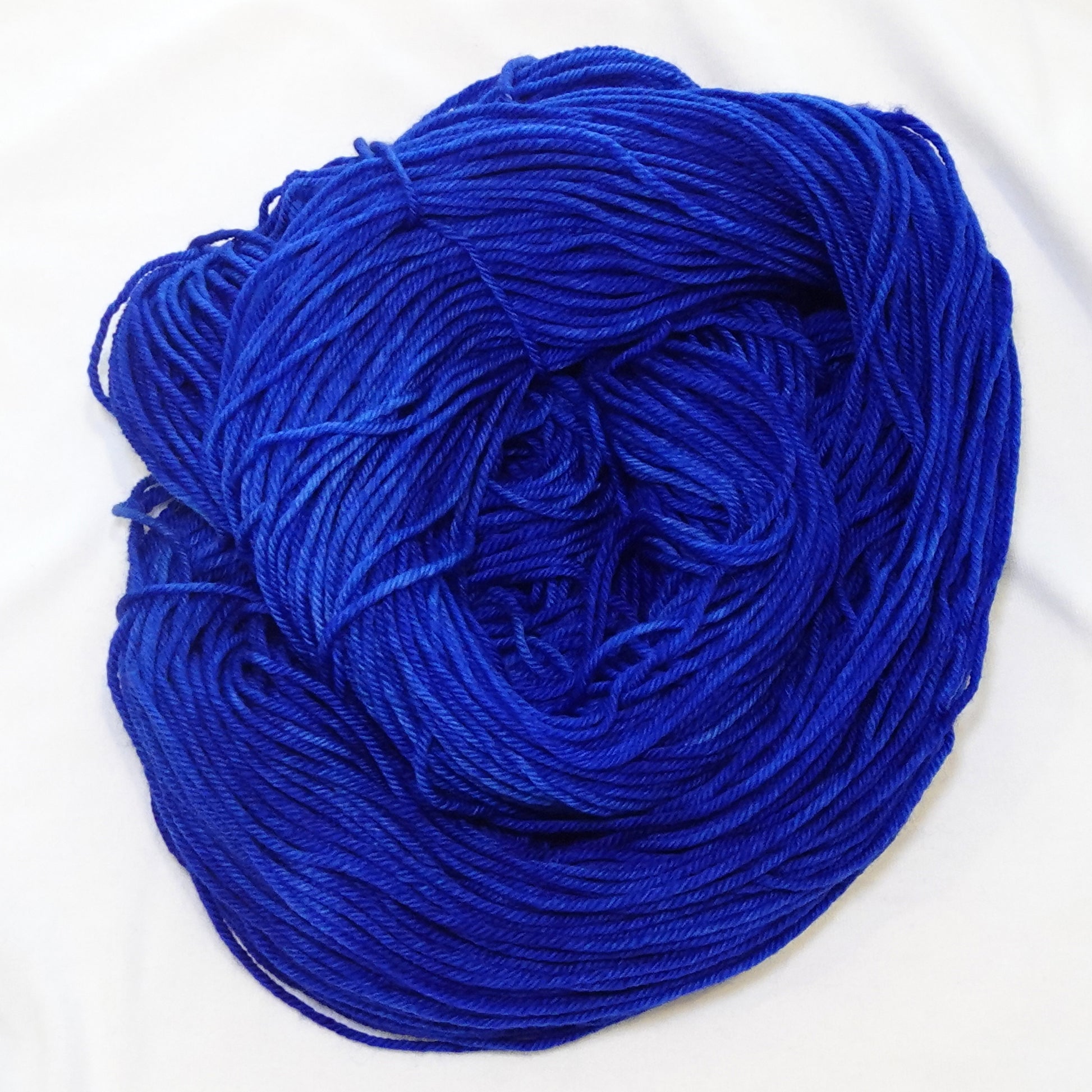 Hand-dyed DK weight yarn in deep royal lapis blue with subtle tonal variation — bold, rich, and regal.