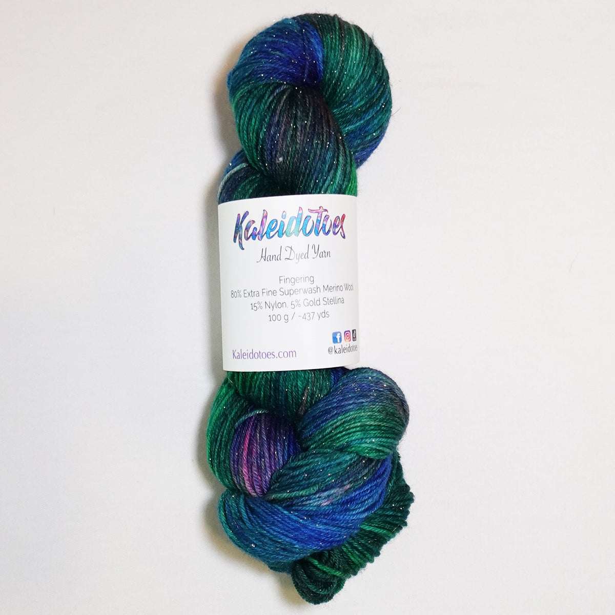 Hand-dyed gold metallic fingering weight yarn in brilliant emerald, deep teal and vivid blue with a fine gold metallic thread.
