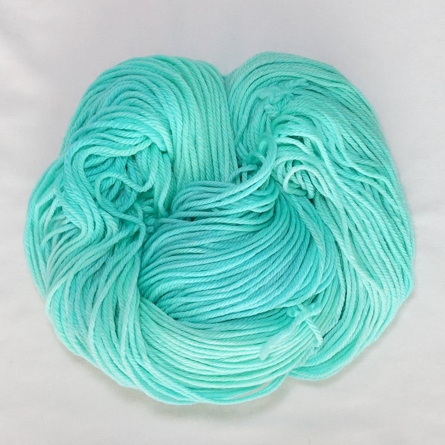 Hand-dyed worsted weight yarn in fresh mint and aqua tones - clean, cool, and luminous throughout.