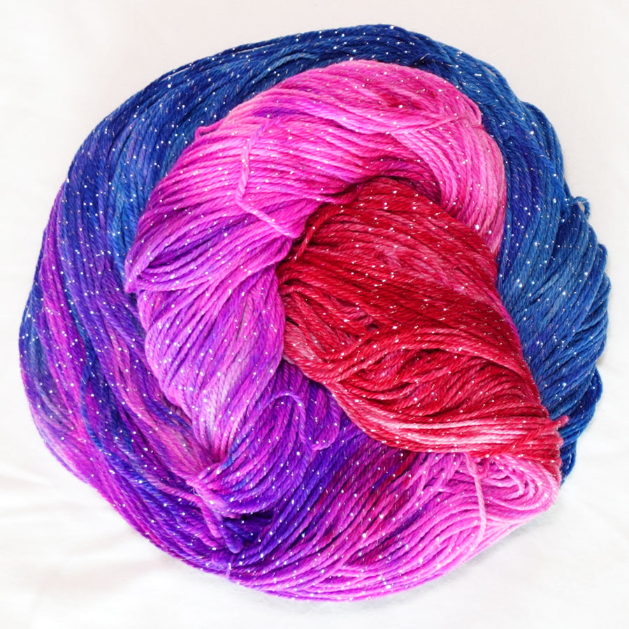 No Curfew hand-dyed fingering weight yarn in brilliant blue, purple, hot pink and red with a fine silver metallic thread.