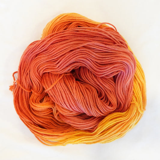 Hand-dyed DK weight yarn in bright orange, deep persimmon, and soft peachy tangerine tones - warm, saturated, and lush.