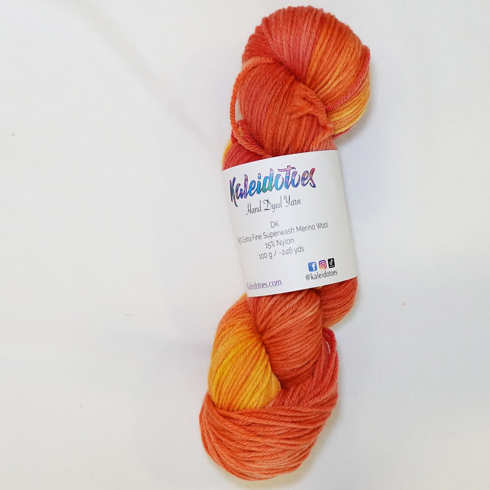 Hand-dyed DK weight yarn in bright orange, deep persimmon, and soft peachy tangerine tones - warm, saturated, and lush.