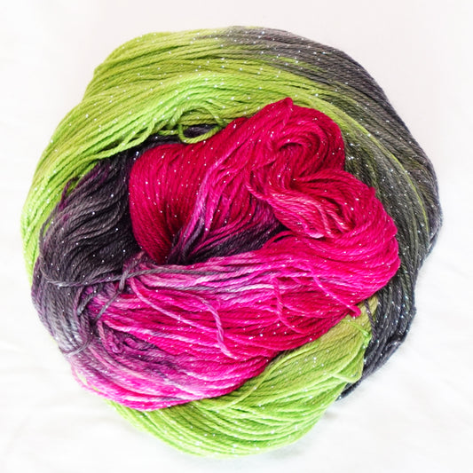 Practically Magic hand-dyed fingering weight yarn in brilliant fuchsia, vivid green and smoky charcoal with a fine silver metallic thread.