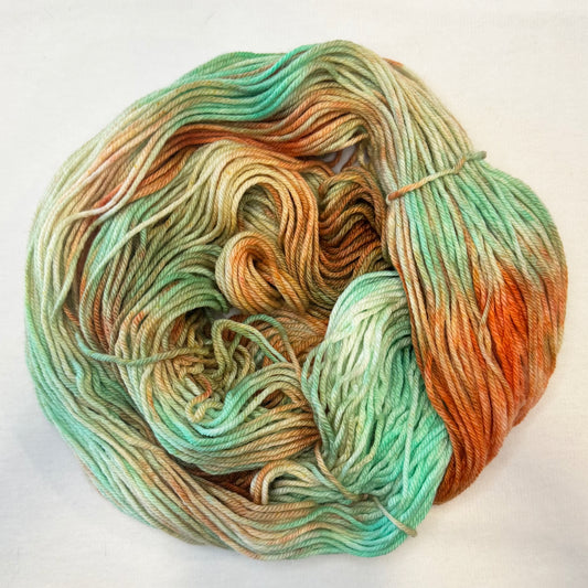 Hand-dyed yarn in soft mint, gold, and copper tones — warm and vintage with subtle modern elegance.