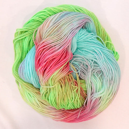 Hand-dyed fingering weight yarn in fluorescent lime, turquoise, Robin's egg blue, hot coral, and soft yellow-green with blended color transitions throughout.