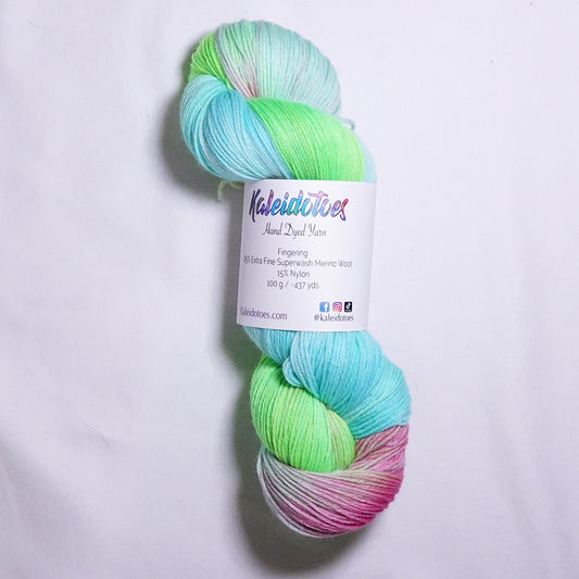 Hand-dyed fingering weight yarn in fluorescent lime, turquoise, Robin's egg blue, hot coral, and soft yellow-green with blended color transitions throughout.