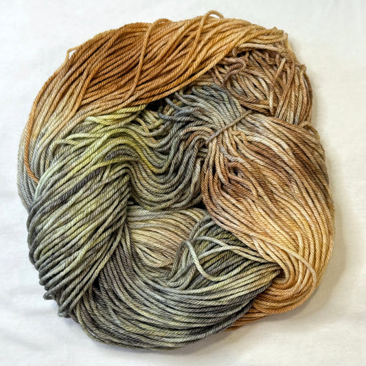Hand-dyed yarn in soft neutrals, warm browns, and wintery greys inspired by cozy knitted mittens.