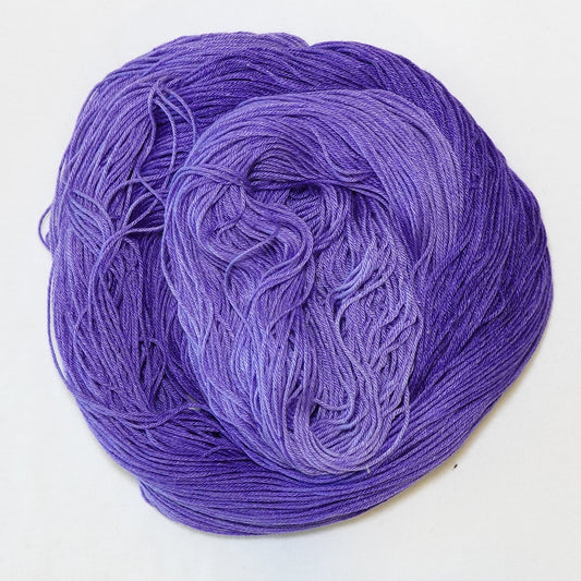 Hand-dyed fingering weight yarn in tonal purple, from deep royal violet to soft lavender.