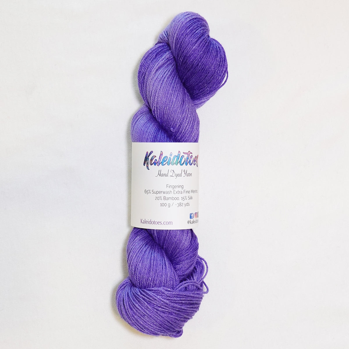 Hand-dyed fingering weight yarn in tonal purple, from deep royal violet to soft lavender.