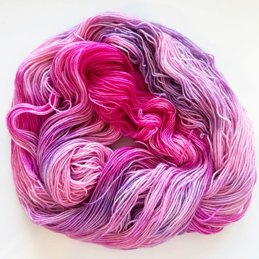 Indie dyed yarn skein, Bloomageddon, deep fuchsia and violet with soft lilac