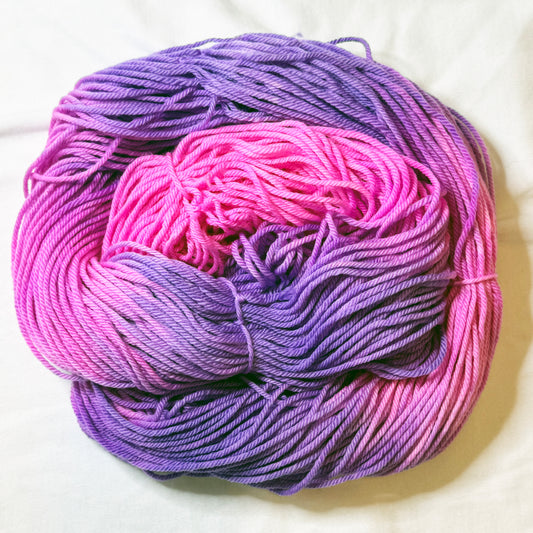 Bloomstruck hand-dyed sock yarn skein in bold magenta, violet, and deep purple tones, small-batch Kaleidotoes yarn made in the USA
