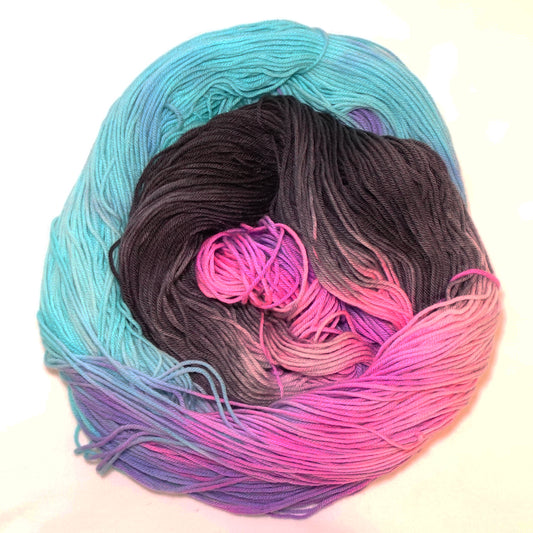 Hand-dyed yarn in vivid aqua, hot pink, and deep black — high-contrast and bold with a striking, graphic feel.