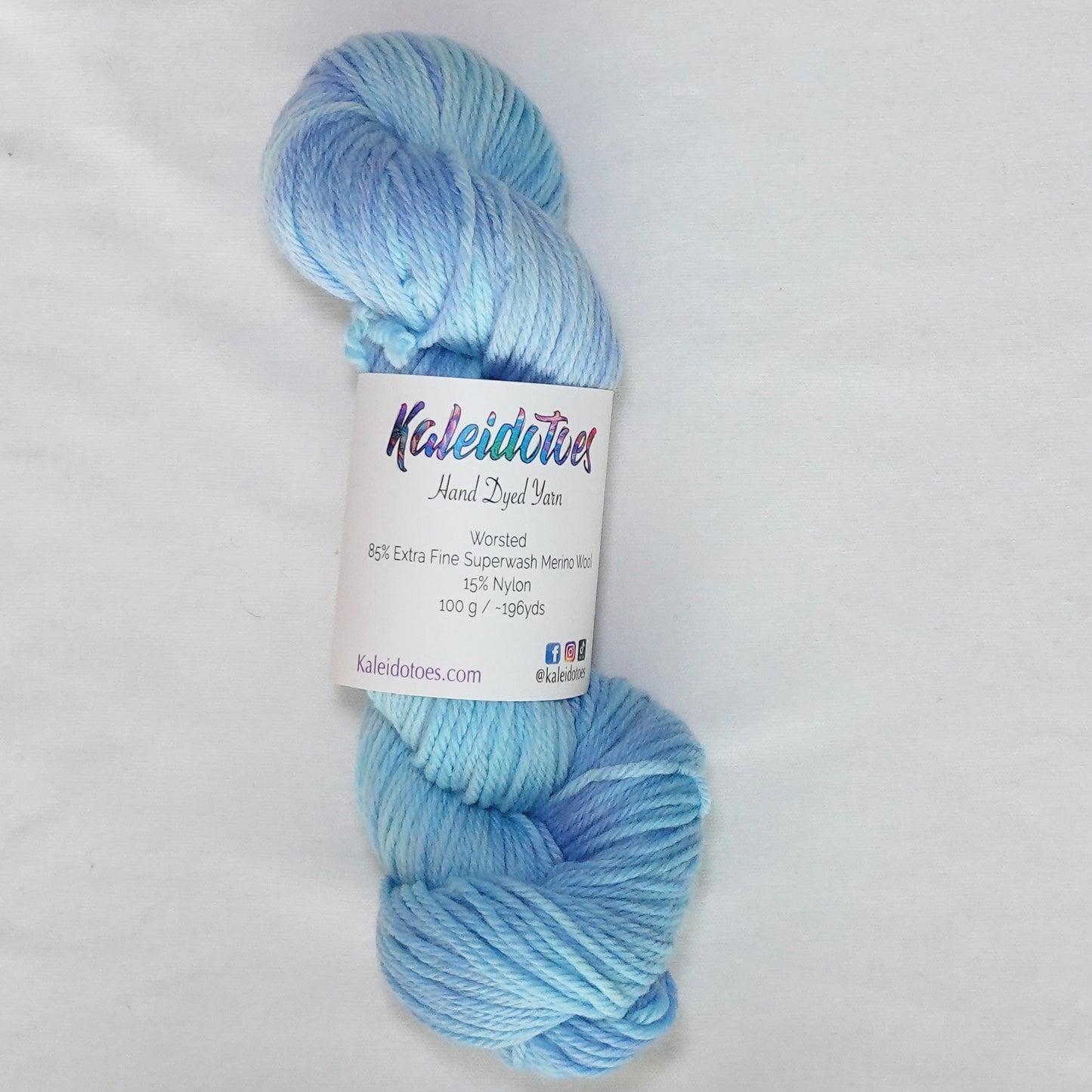 Hand-dyed worsted weight yarn in soft sky blue and periwinkle with light ice blue tones throughout.