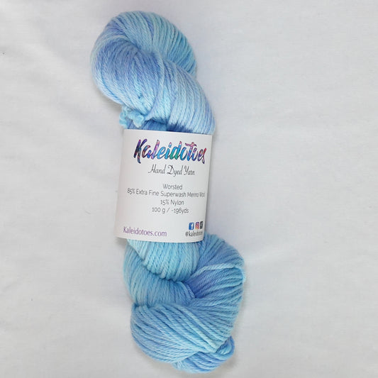 Hand-dyed worsted weight yarn in soft sky blue and periwinkle with light ice blue tones throughout.