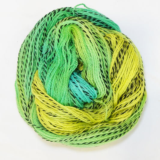 Hand-dyed fingering weight yarn in electric chartreuse, lime, and light emerald with black twisted through throughout.
