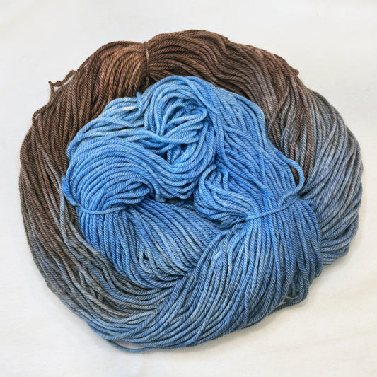 Hand-dyed yarn in weathered denim blue and warm brown tones — rustic, relaxed, and full of cozy charm.