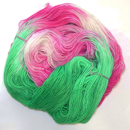Hand-dyed yarn in bold green, hot fuchsia pink, and soft white — bright, playful, and summer-ready.