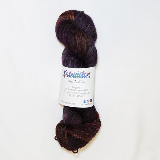 Hand-dyed fingering weight yarn in deep plum, smoky violet, rust, amber, and magenta with shadowy tonal depth throughout.