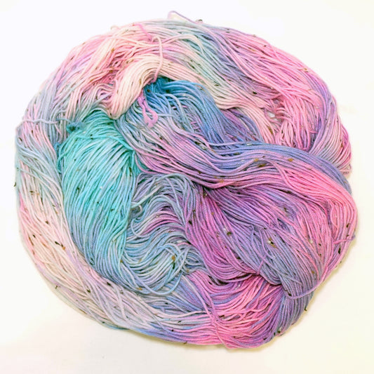 Hand-dyed tweed yarn in soft pink, periwinkle, and pale lavender tones with subtle flecks — dreamy, airy, and softly layered.