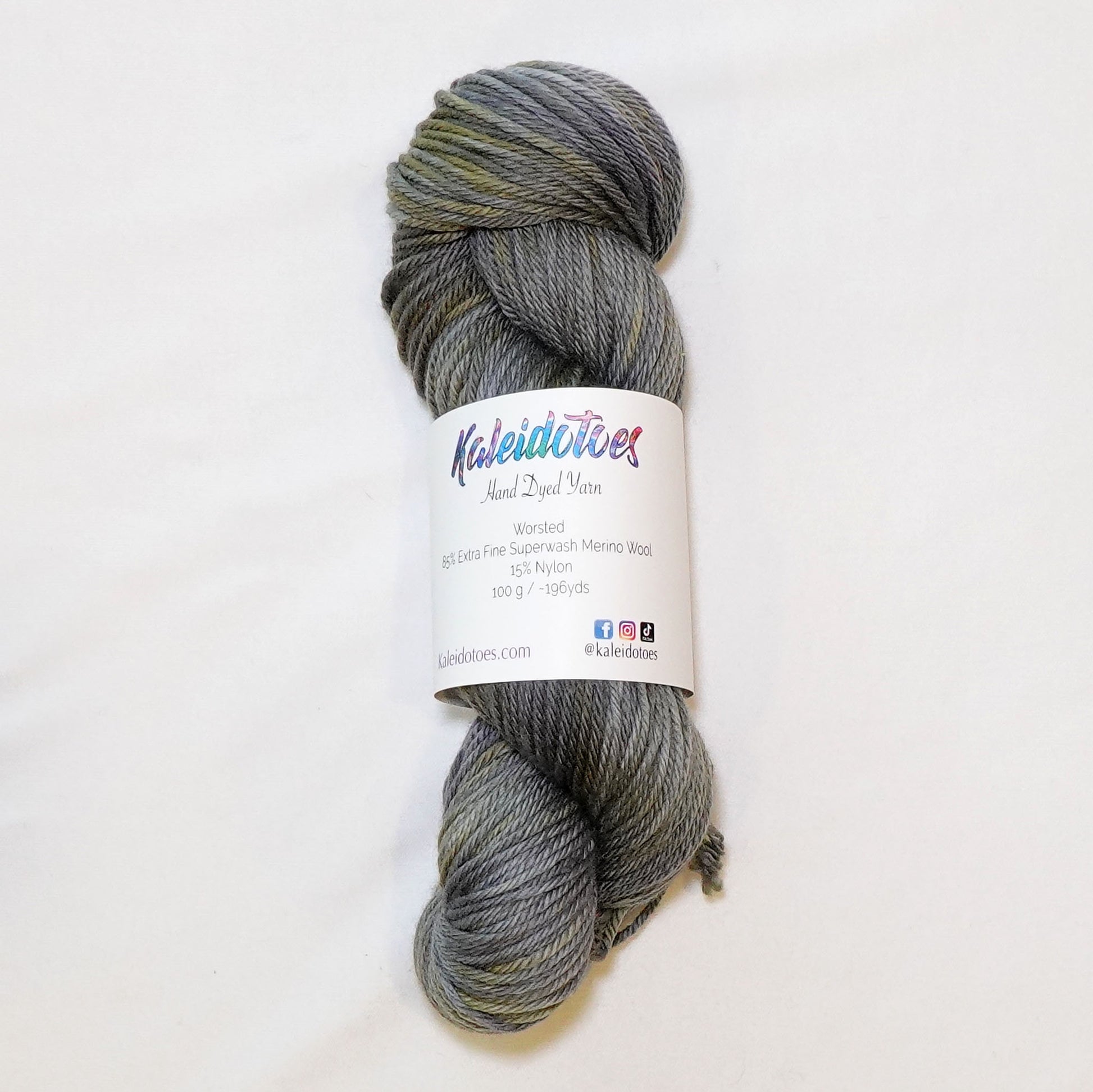 Hand-dyed worsted weight yarn in cool grey with unexpected warm gold undertones and random golden variation.